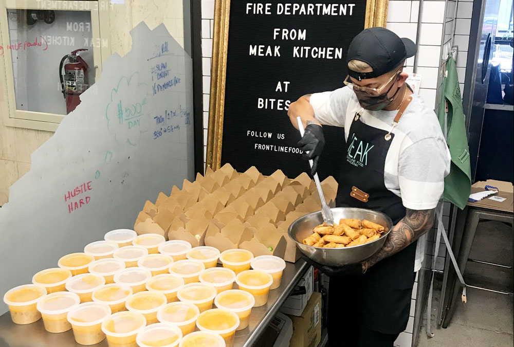 Team Member Kamusa Som dishes out food for Frontline Foods Phoenix